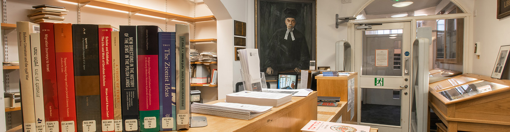 A wooden desk with books on it