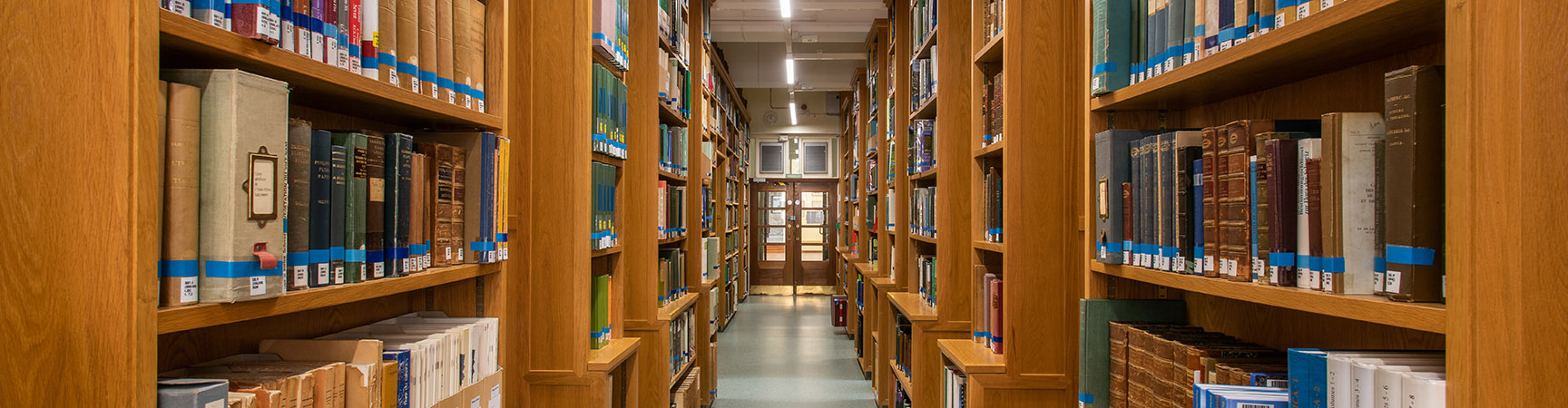 Two rows of bookshelves on either side of a walkway